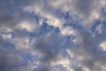 sun and cumulus white clouds against a beautiful blue sky