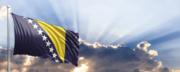 Bosnia and Herzegovina flag on blue sky. 3d illustration