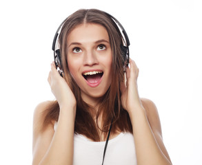 Young woman listening to music. Happy and headphones.