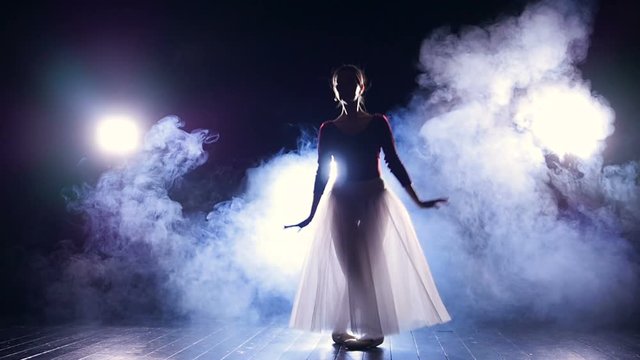 A ballerina makes perfect echappes in the dark. 