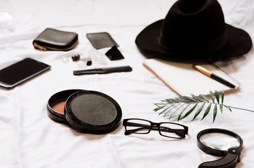 Fototapeta na wymiar magnifier for the traveler. glasses and hat. phone