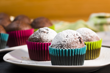 Chocolate muffins sprinkled with icing sugar