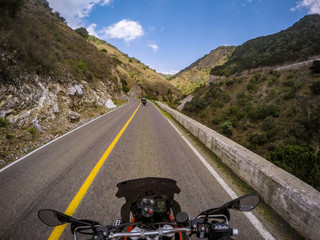 POV ridding a motorcycle on a road - 175125170