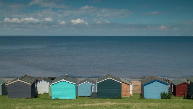 Time lapse of traditional english beach huts in whistable, kent, england on a summer's day