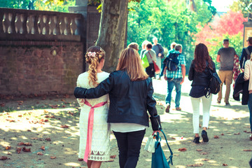 friends walking outdoors in autumn on wedding day