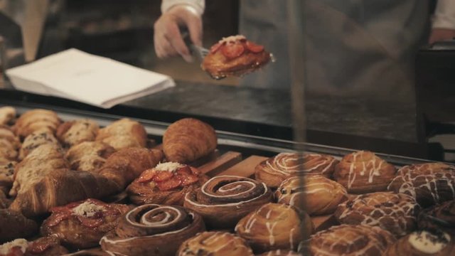 Bakery and confectionery products cake shop And desserts, hands with fresh bakery products near shop window