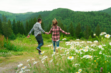 Young couple in love walking in mountains.