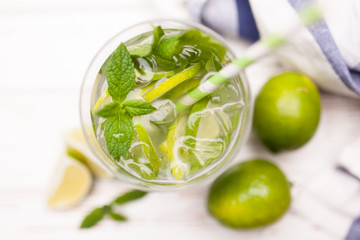 Mojito cocktail on white wood background