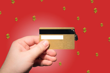 hand holding credit card on the red background