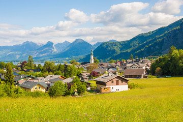 Fototapeta na wymiar Beautiful view of green alpine meadow and mountain village St. Gilgen, Salzkammergut, Austria.
