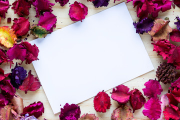 flowers dried aromatic, with paper, sheet, on wood background