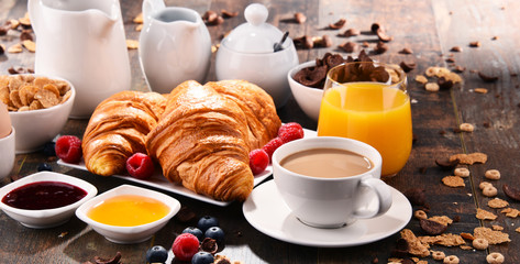 Breakfast served with coffee, juice, croissants and fruits