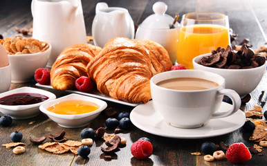Breakfast served with coffee, juice, croissants and fruits