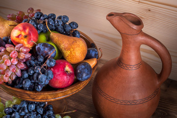 autumnal fruit still life with Georgian jug on rustic wooden table background