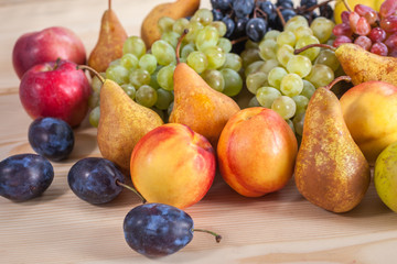 autumnal fruit still life on rustic wooden table background