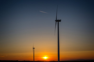 Fototapeta na wymiar Windmills in the sunset light from Hungary