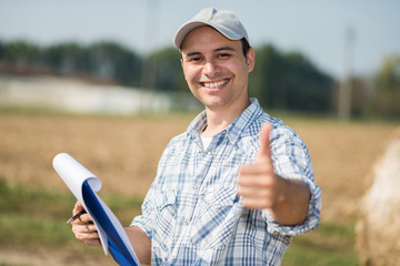 Portrait of a smiling farmer giving thumbs up