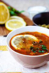 Solyanka Russian soup with olives and lemon.