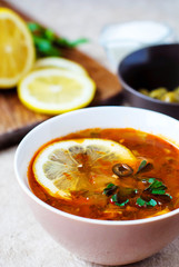Solyanka Russian soup with olives and lemon.