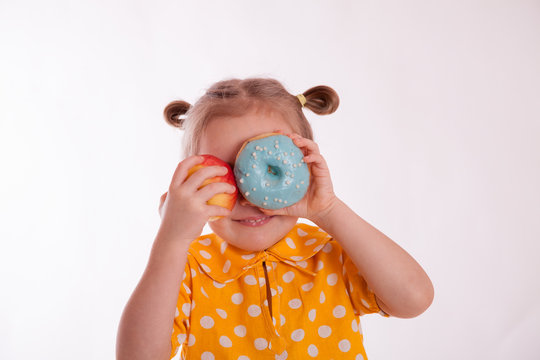 cheerful girl with a donut and an apple