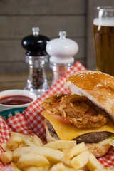Burger and french fries on wooden table