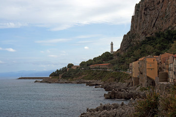 Fototapeta na wymiar Sea shore of Cefalu with lighthouse on the mountain side, Sicily, Italy