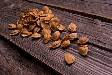 apricot pits on the old wooden table