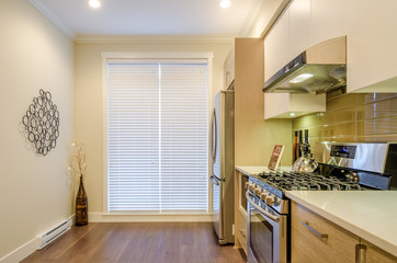 Modern, bright, clean, kitchen interior with stainless steel appliances in a luxury house.