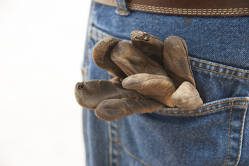 Leather work gloves in back denin jeans pocket