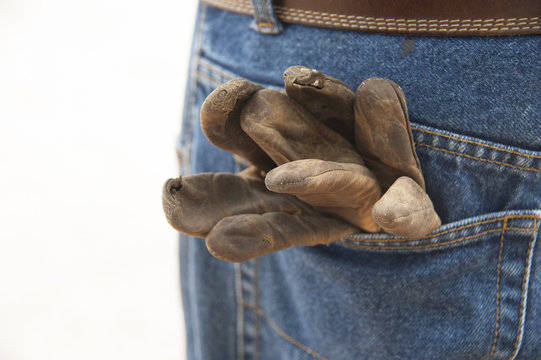 Leather work gloves in back denin jeans pocket