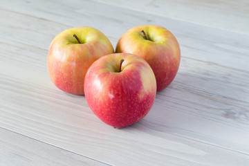 three small red apples