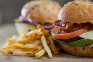 Hamburger and french fries on wooden table