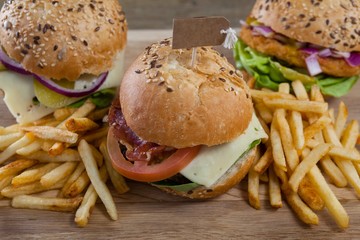 Various hamburger with tag and french fries on wooden table