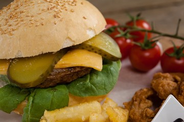 Hamburger and french fries on wooden table