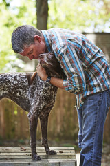 a man petting his dog