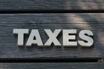 High Angle View Of  Tax Word On Wooden Background