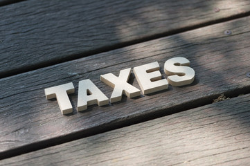 High Angle View Of  Tax Word On Wooden Background