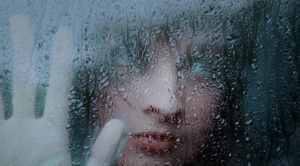 Sad young woman and a rain drops