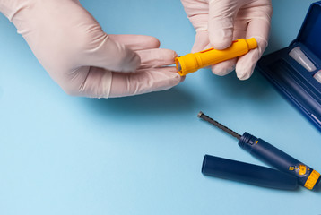A man holds a syringe for subcutaneous injection of hormonal drugs in the IVF protocol in vitro fertilization . pregnancy.