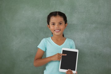 Young girl holding digital tablet