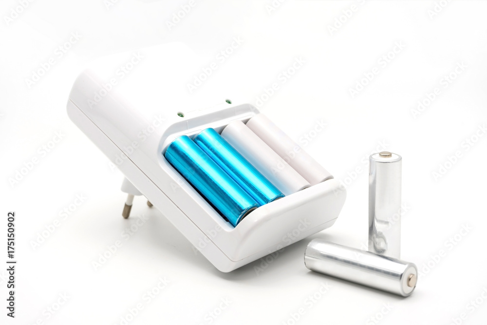 Wall mural aa batteries rechargeable in accumulator charger, isolated on a white background