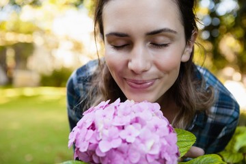 Fototapeta premium Close-up of woman with eyes closed smelling purple hydrangea