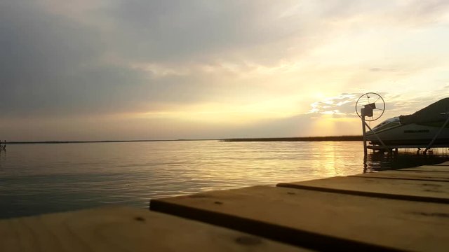 Time-lapse of Lac St. Anne of off pier in Alberta, Canada. End focuses on pier 