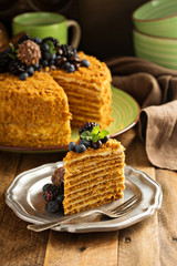 Honey layered cake with candy and berry