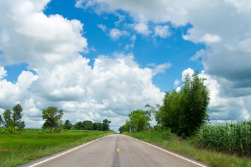 Fototapeta premium The asphalt road is the straightest line to see the sky with white clouds.