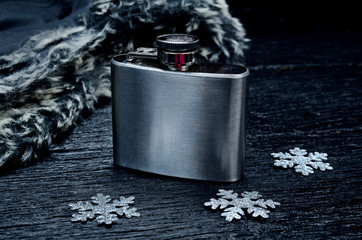 metallic bottle for alcohol on table