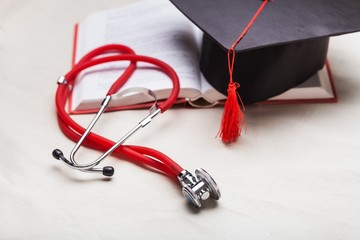 Stethoscope and graduate hat.