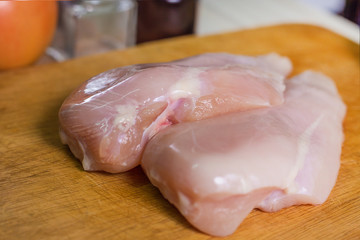 The Raw chicken breast with dill ready to cooking
