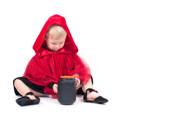 Little Red Riding Hood. Beautiful little girl in a red raincoat. Halloween