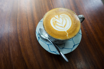 Hot coffee latte art on wood table